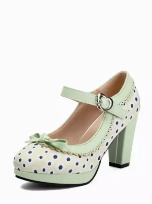 Mint green polka dot Mary Jane pumps with white polka dots and decorative toe bow, front three-quarter view featuring chunky block heel and round toe design