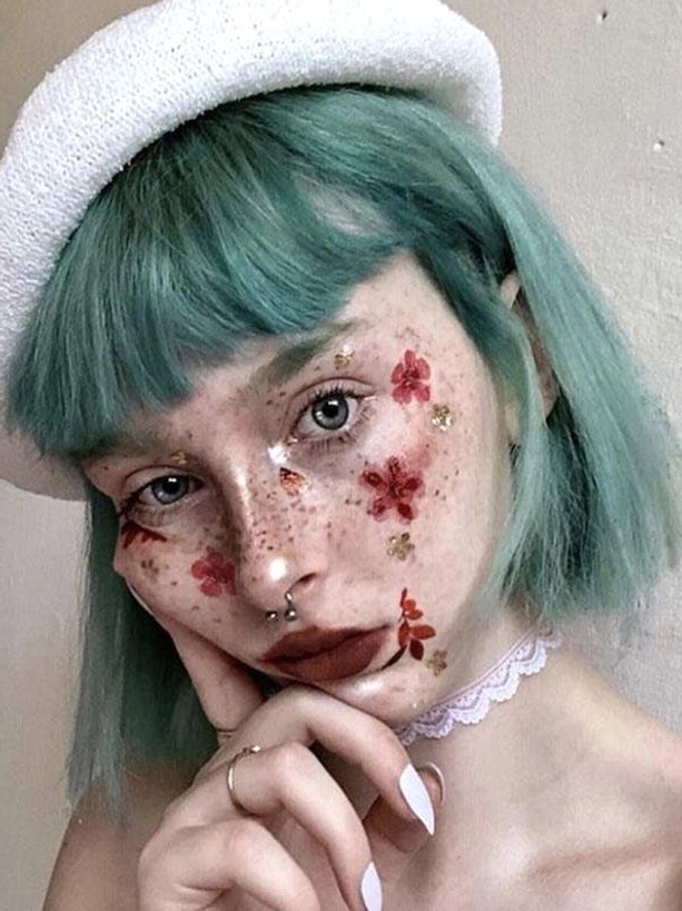 Mint green short bob lolita wig with blunt bangs on model wearing beret and choker with face flower decals, romantic rococo aesthetic portrait view
