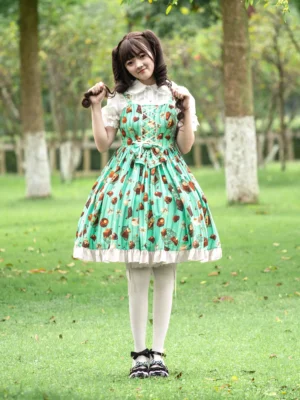 Sweet Lolita chocolate cake print mint green dress with twin hair buns styled look and black Mary Jane shoes outdoor photography
