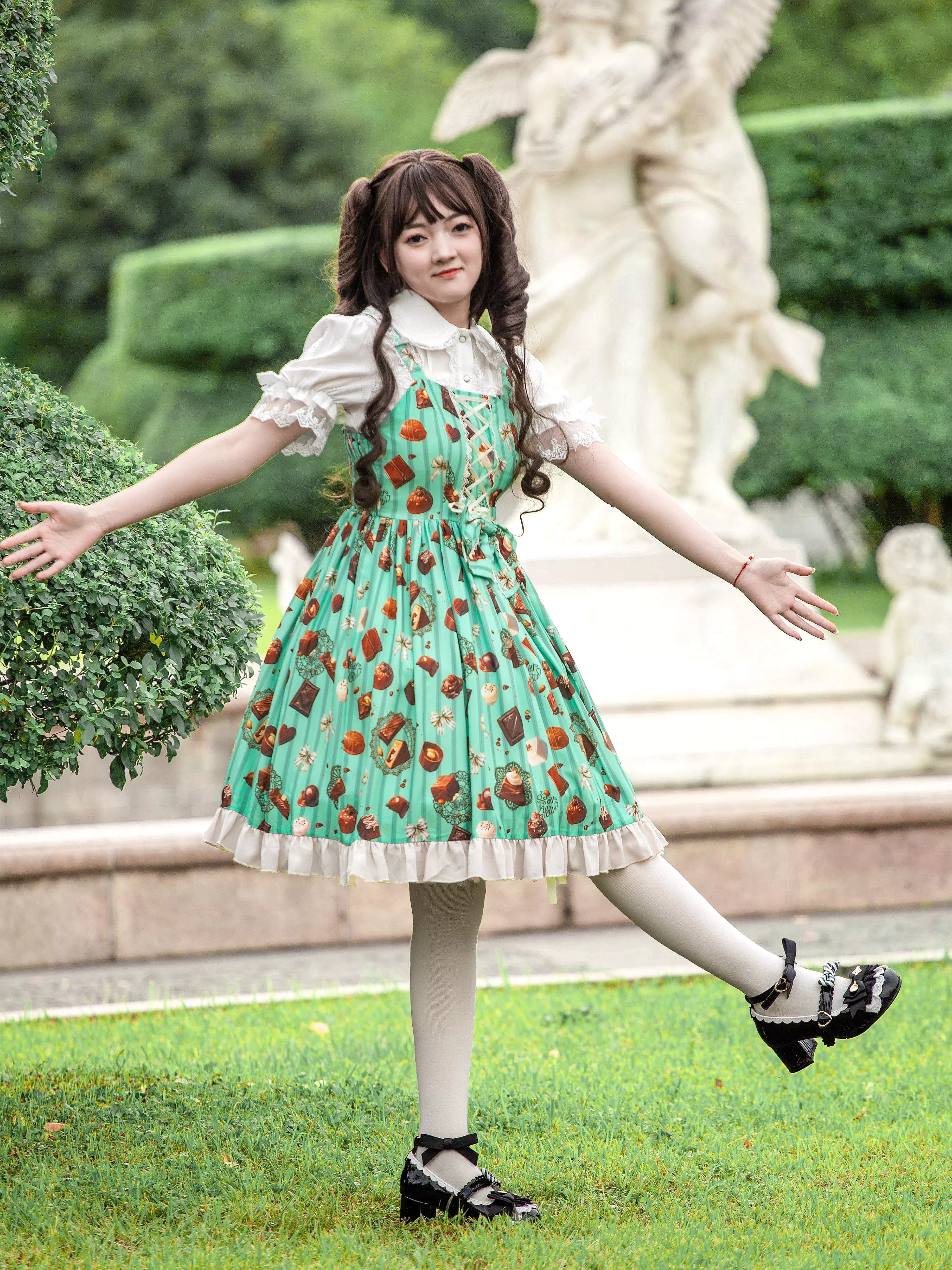 Side view mint green chocolate cake sweet Lolita JSK dress with arms outstretched showing ruffles movement and design details