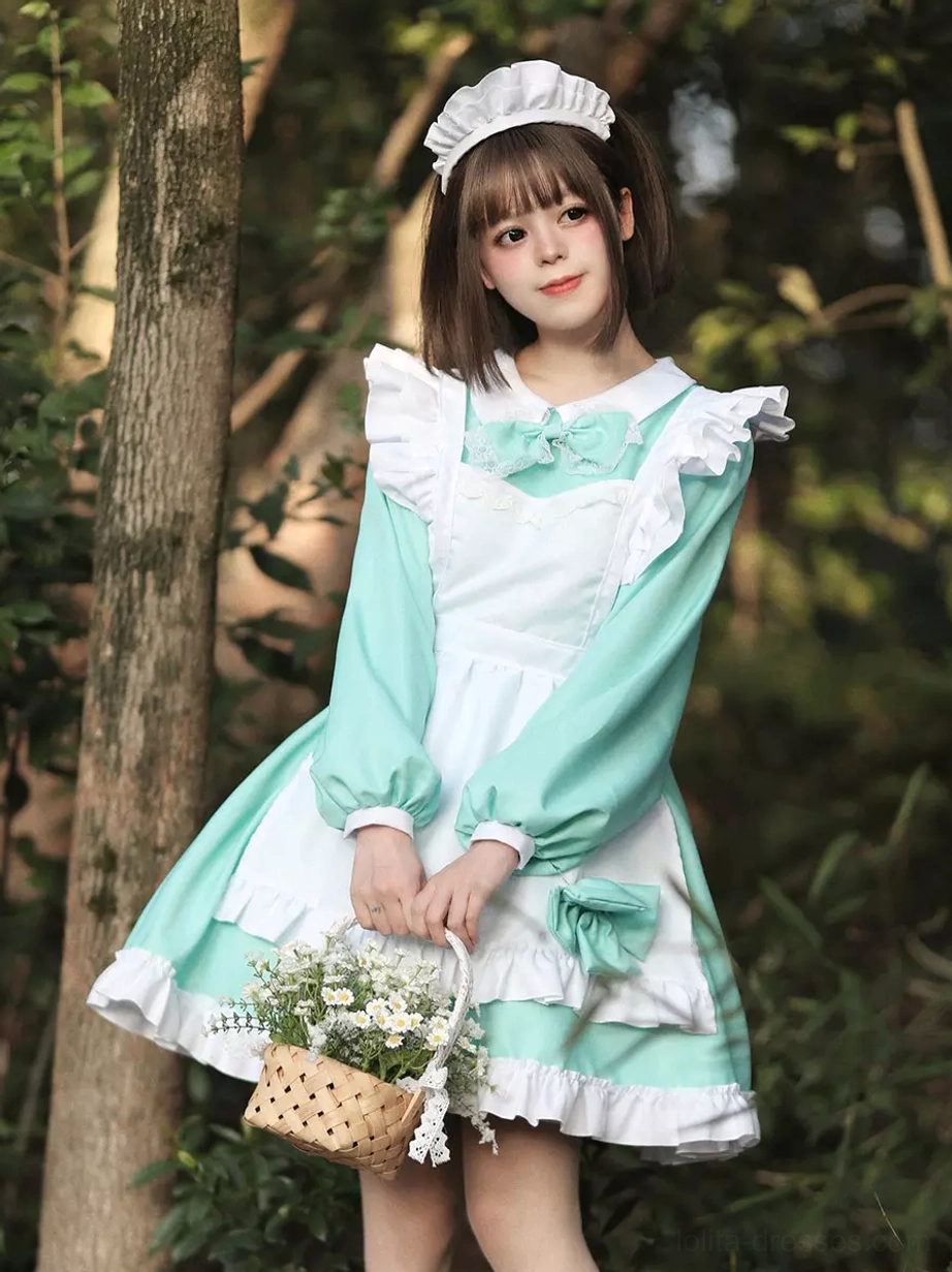 Mint green maid lolita mini dress with ruffles and bow trim worn by model holding flower basket in forest
