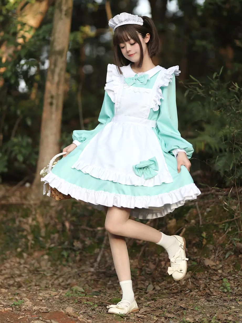 Mint green maid lolita mini dress full length front view worn with white socks and shoes outdoor forest
