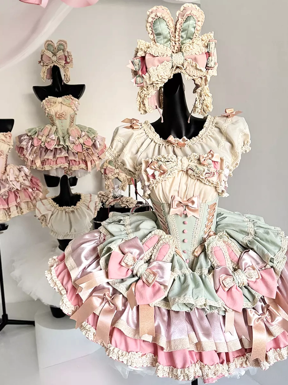 Multiple sweet lolita bunny ear fairy dresses displayed on dress forms showing full costume coordination with headpiece sets