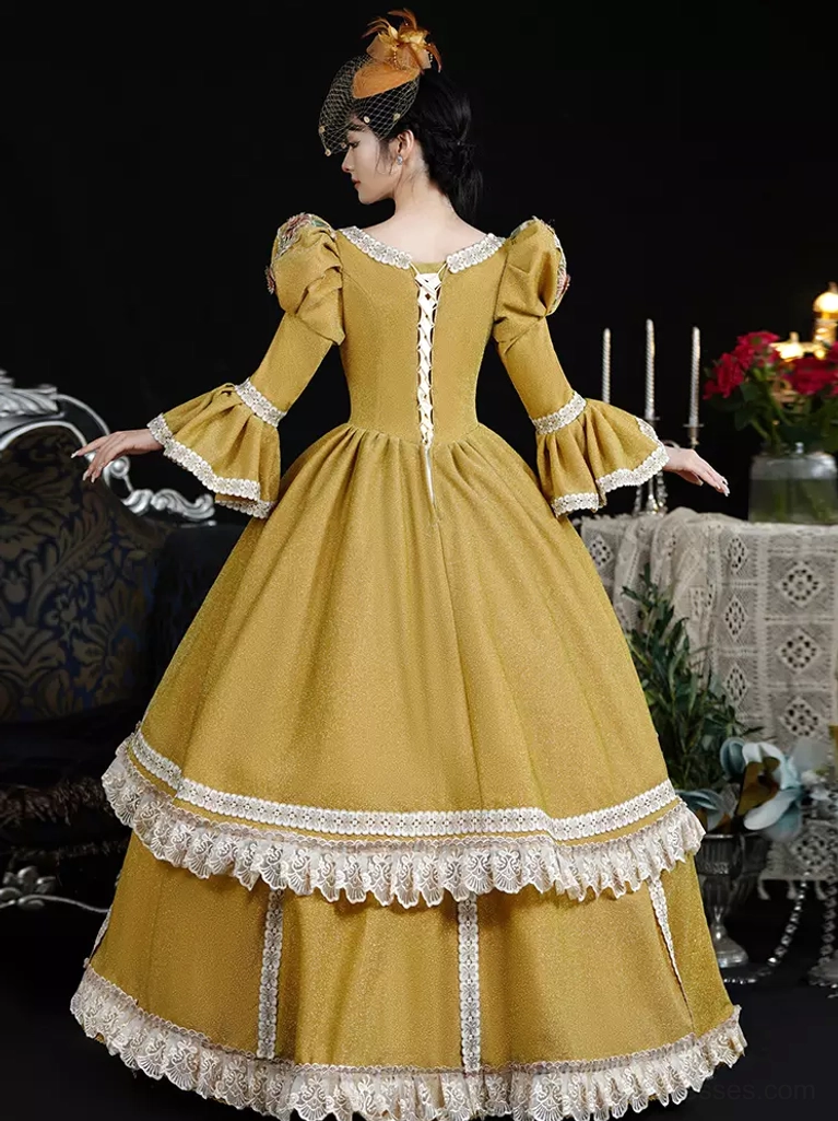 Back view of lolita rococo gown displaying lace-up closure, double-layer lace hem detailing, full circle skirt architecture, and vintage headwear