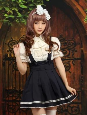 Navy blue Classic Lolita salopette skirt with beige stripe trim, full front view on model wearing white ruffled blouse and white socks in retro garden setting