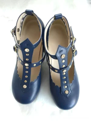 Navy blue lolita t-strap pumps with metal rivet details and scalloped trim, top-down flat lay view displaying adjustable ankle buckles and embellishment placement