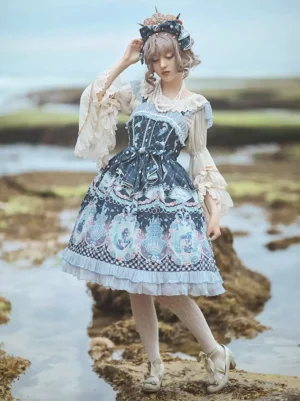 Navy blue mermaid Lolita jumper skirt dress with square neck and waist bow detail shown in side three-quarter view at coastal reef area with model wearing matching headdress