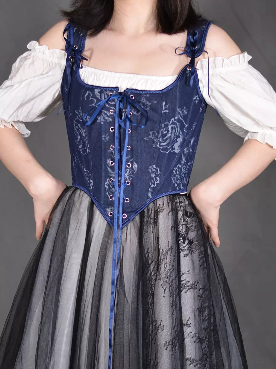 Navy rose floral corset bustier front view with adjustable bow shoulder straps and metal eyelet lace-up closure worn with off-shoulder blouse and tulle skirt