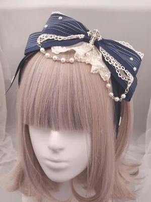 Navy blue striped classic lolita headband with pearl chain and white lace ruffle bow metallic cross embellishment displayed on mannequin with purple-highlighted bob wig front view