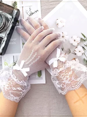 Light neutral tone lace fishnet gloves featuring ruffled lace cuffs with delicate white bow accents shown in overhead flat lay composition with vintage props matching gothic lolita aesthetic