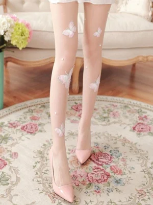 Full-length leg shot of Sweet Lolita butterfly stockings worn with pink pointed stilettos on vintage floral rug, showing butterfly and pearl embroidery pattern