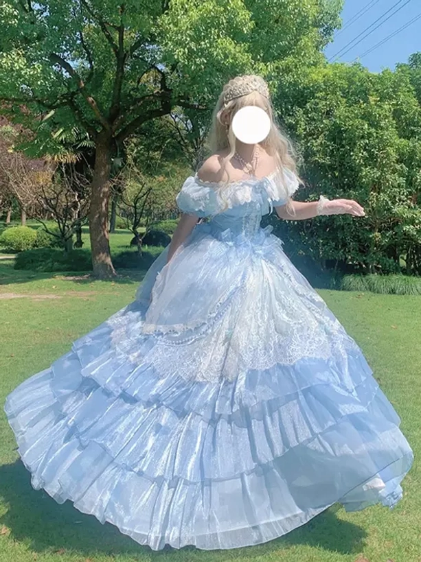 Light blue off-shoulder Lolita gown side back view displaying flowy layered skirt, short ruffled sleeves, and romantic fairy-tale silhouette