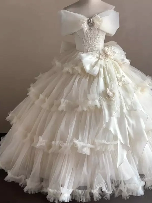 Off-shoulder Classic Lolita wedding dress with rhinestone bow and embroidered lace bodice front view on mannequin