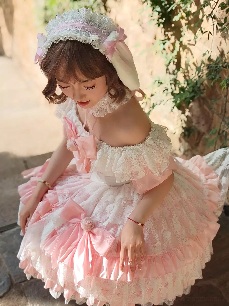 Off-shoulder sweet lolita dress close-up front low angle view with fluffy multi-layered skirt front pink bows and flower decor