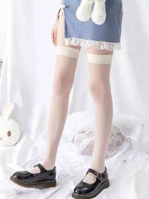 Off-white sheer lolita knee-high socks with wide solid cuff paired with blue lace-trimmed mini skirt and black Mary Jane shoes, showcasing ethereal mesh texture in classic lolita fashion styling