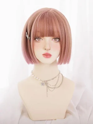 Front view ombre pink sweet lolita bob wig with blunt bangs styled on mannequin wearing layered crystal necklaces