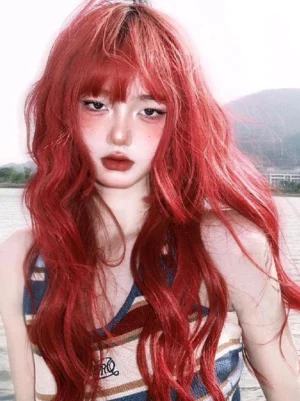 Long orange-red wavy lolita wig with blunt bangs - eye-level frontal close-up view of heat-resistant fiber sweet harajuku style wig on model outdoors
