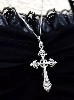 Ornate aged silver cross pendant necklace with delicate silver box chain displayed on black lace fabric, showcasing intricate carved details and gothic aesthetic for lolita fashion