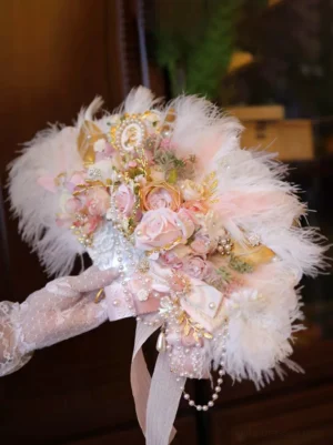 Ostrich feather artificial rose bridal bouquet held by lace-gloved hand, side front view with pink roses, ostrich fluff, and pearl tassels - lolita wedding prop