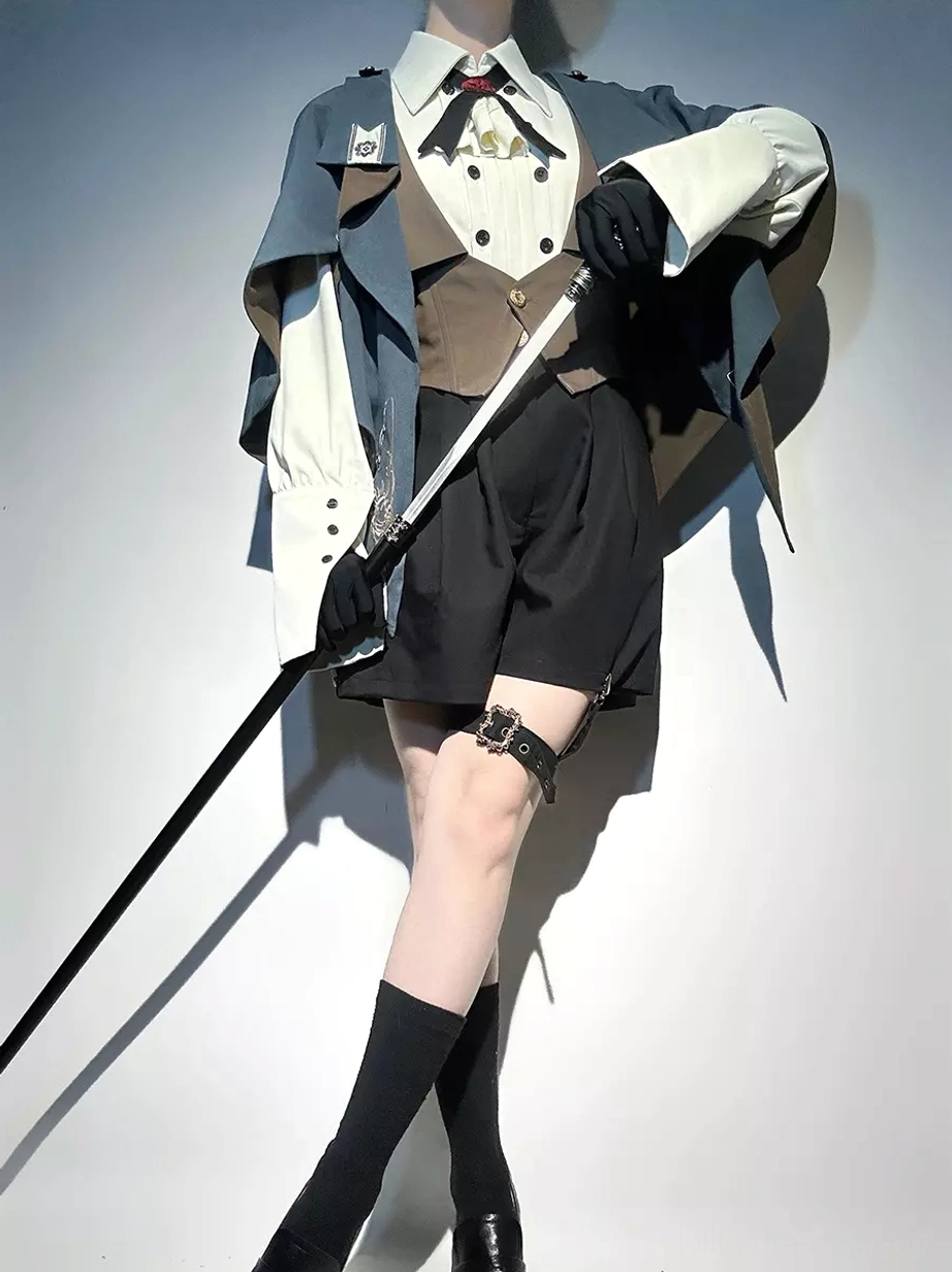 Ouji lolita gentleman three-quarter view showing dark navy cape with formal white shirt and matching necktie styling with black gloves