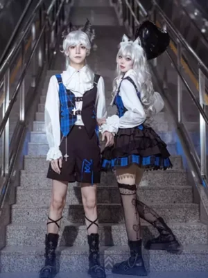 Ouji and Gothic Lolita couple outfit set featuring matching blue plaid vests, cross decorations, and coordinated dark fashion at subway stairwell venue