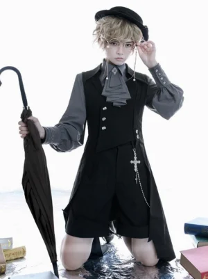 Ouji lolita overcoat front kneeling view androgynous model asymmetrical tailcoat cross chain ornament grey shirt wet floor book props gothic aesthetic