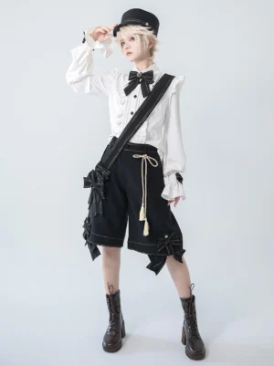 Aristocratic Ouji Lolita blouse complete full-body ensemble white long sleeve ruffled shirt with black bow tie and bow-adorned shorts military hat leather boots androgynous model studio background