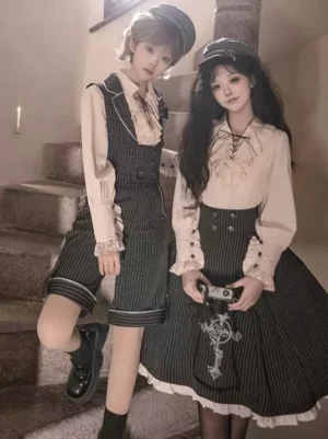 Ouji Lolita twin coordinate set featuring black striped vests with matching off-white blouses and newsboy caps on stairs