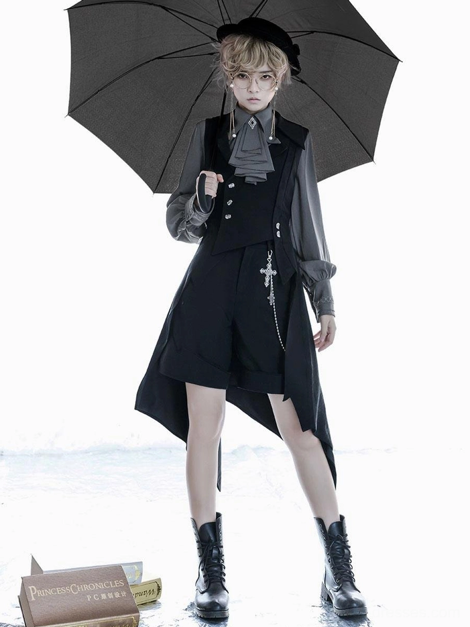 Ouji style lolita overcoat full front standing view double-breasted vest ascot tie cropped shorts combat boots holding black umbrella seaside book props