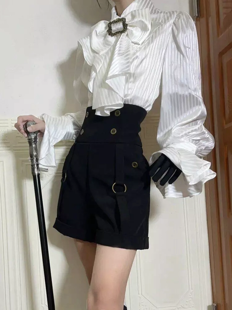 White blouse with black ouji lolita shorts front pose holding walking cane, flared puff sleeves ruffled bow neck decoration