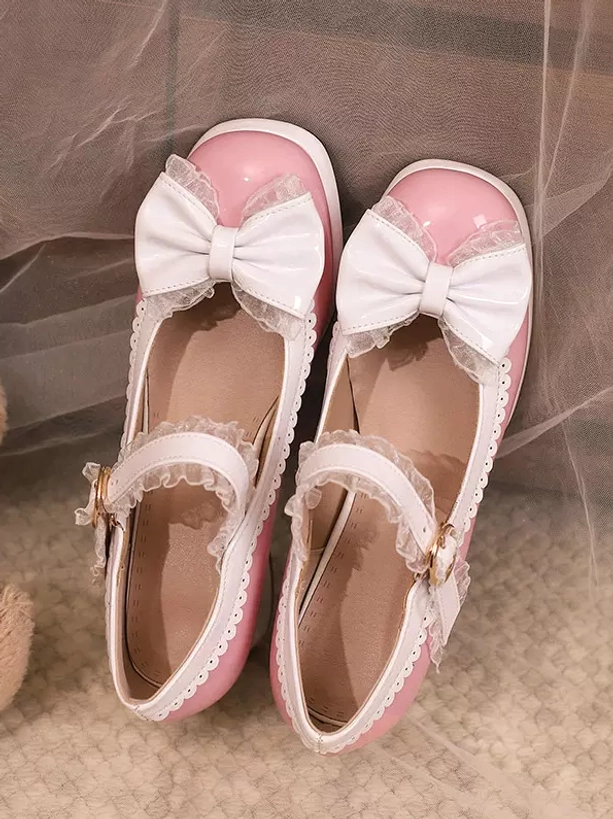 Pair of pink Lolita Mary Jane chunky pumps with round toe white bow and lace trim flat lay top view