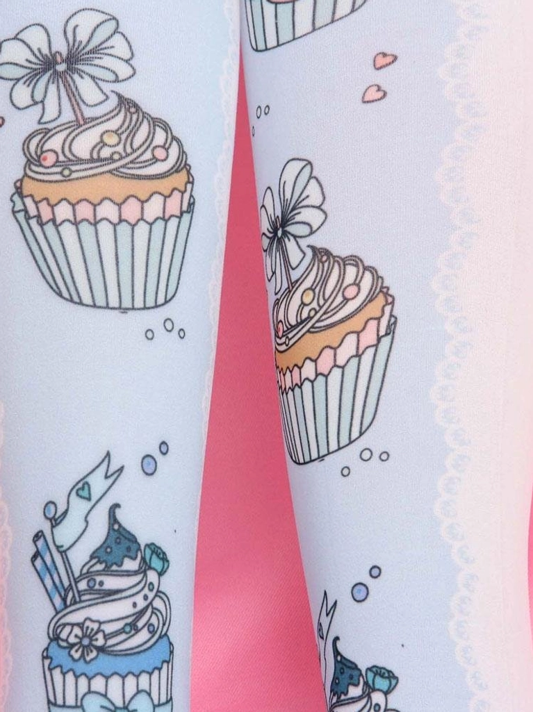 Close-up detail of pastel blue Lolita socks showing lace trim detailed cupcake dessert prints and heart dot accents