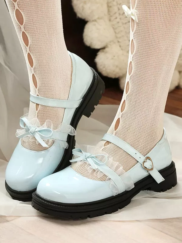 Pastel blue lolita mary jane shoes overhead side view double feet with light blue patent leather ruffle bow, black chunky sole and heart buckle