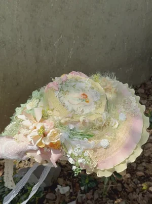 Pastel floral lace bonnet vintage lolita headdress with ruffled brim and artificial flowers front oblique view