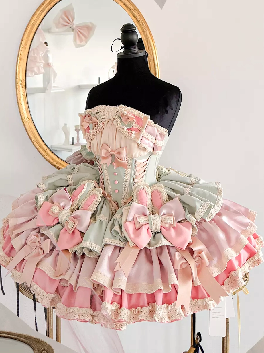 Pastel green sweet lolita bunny ear fairy dress with multi-layer ruffles and satin bow front flat view on dress form