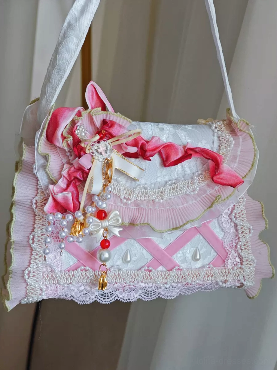 Pastoral lolita fabric strap handbag side front view with delicate fabric shoulder strap, pink bow decoration, pearl tassel pendant, and lace trim details