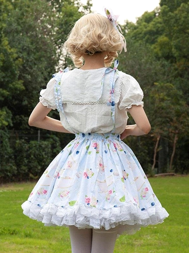 Pastoral style lolita skirt with ruffled hem light blue floral print and white puff-sleeve blouse back three-quarter view outdoor