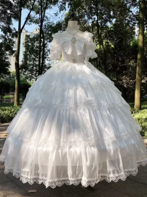 Pearl white sweet Lolita wedding dress front view with puffed sleeves, crystal brooch bow, pearl waist trim, and layered tulle skirt with lace hem