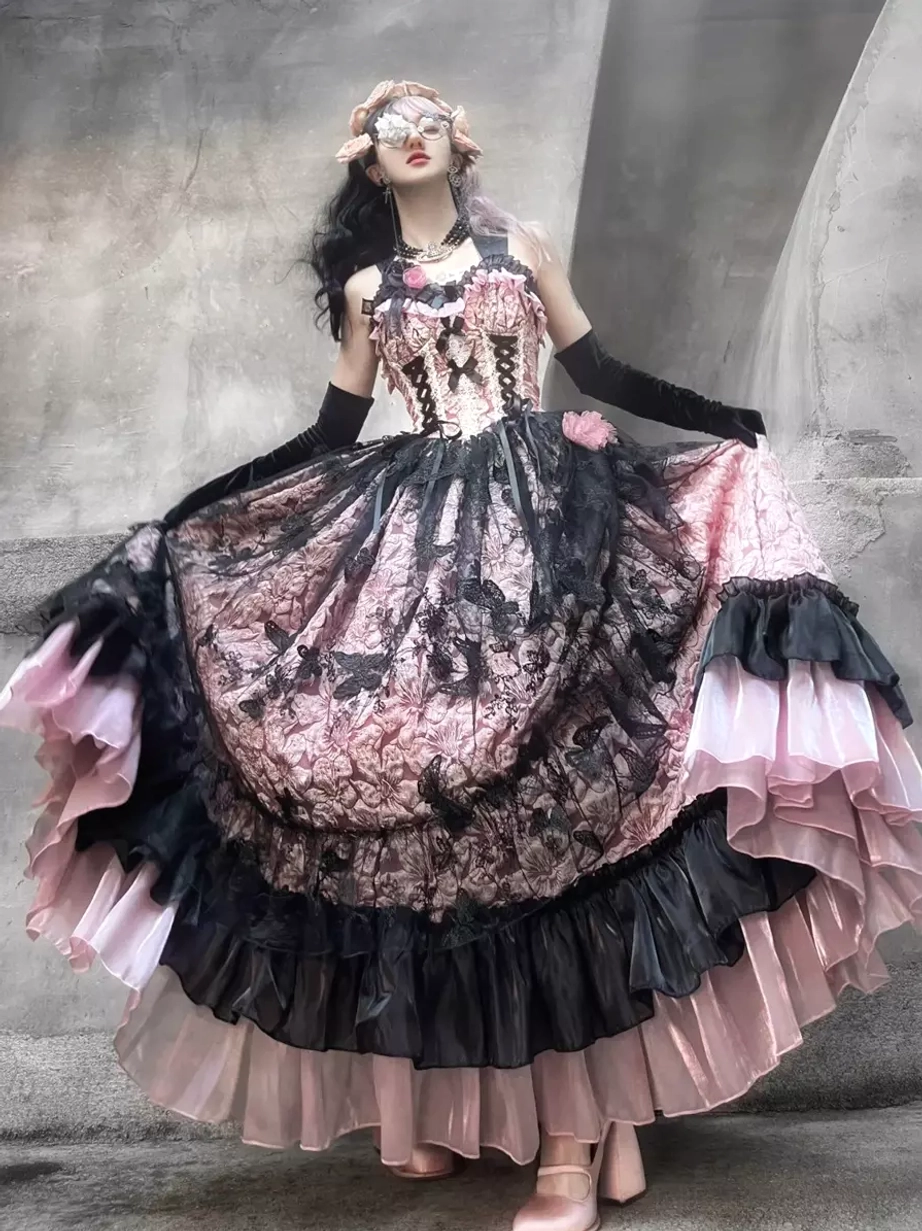 Full rotating model display of pink and black gothic Lolita ball gown with multi-layered ruffled skirt and floral headpiece accessory