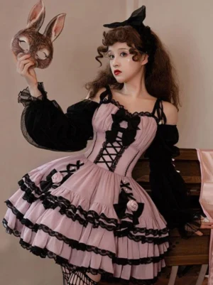 Pink black Gothic Lolita dress front three-quarter view with black lace-up bodice and ruffled tiered skirt on model wearing rabbit mask