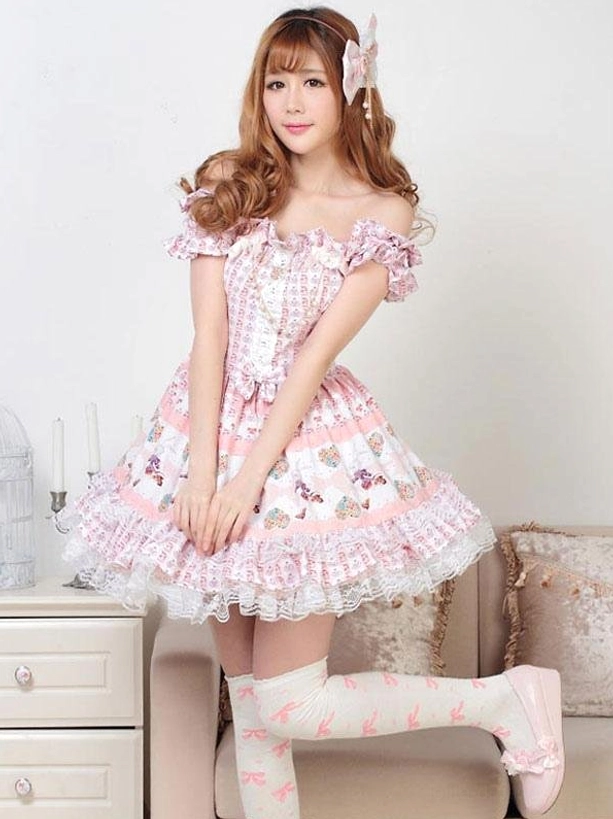 Pink lolita dress side front view with printed over-the-knee socks and flat shoes model wearing matching hair bow