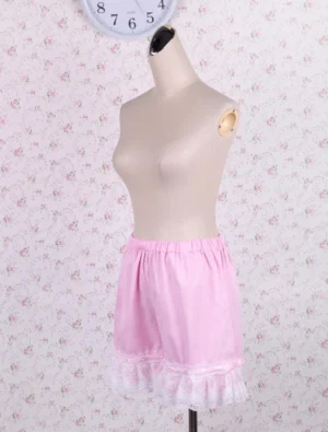 Left side view of pink lolita bloomers showing the silhouette, elastic waist construction, and white lace trouser hem detail in authentic lolita fashion style