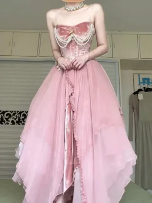 Pink fairy lolita evening gown featuring bow-adorned velvet bust, pearl necklace accent, and ruffled tulle skirt edges - front straight view showing structured bodice