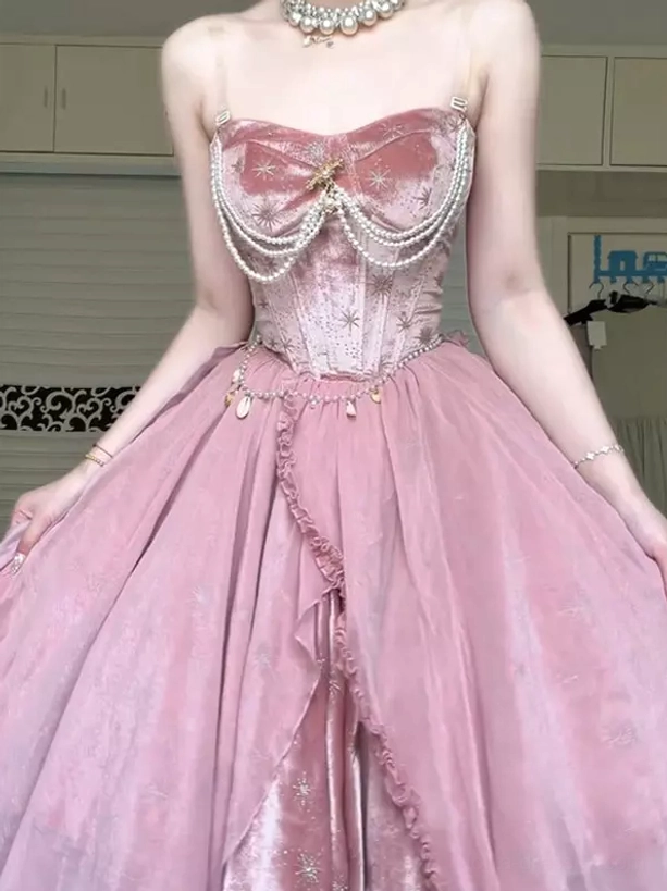 Front close-up side view of pink fairy lolita corset dress with pearl choker necklace, star brooch accent on bust, and voluminous layered tulle skirt construction