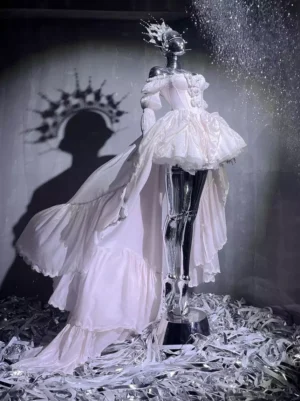 Pink fairy lolita dress with dramatic train and tiered ruffles on mannequin 3/4 view