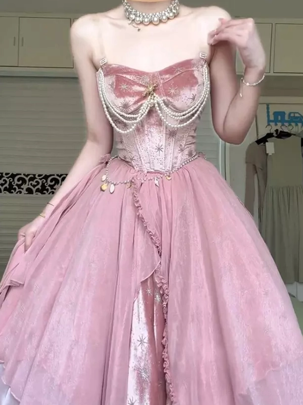 Close-up front three-quarter view of pink fairy lolita maxi gown with thin spaghetti straps, waist pendant chain, and star embroidery detail on tulle skirt