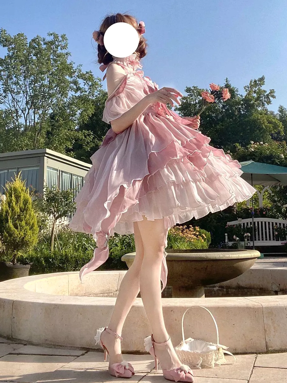 Pink fairy lolita princess gown side front full view with gradient pink ruffled skirt off-shoulder halter top model holding pink flowers and matching high heels