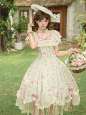 Pink floral sweet lolita tea party dress with ruffled short sleeves and tulle hem worn by model in outdoor garden setting with flower basket