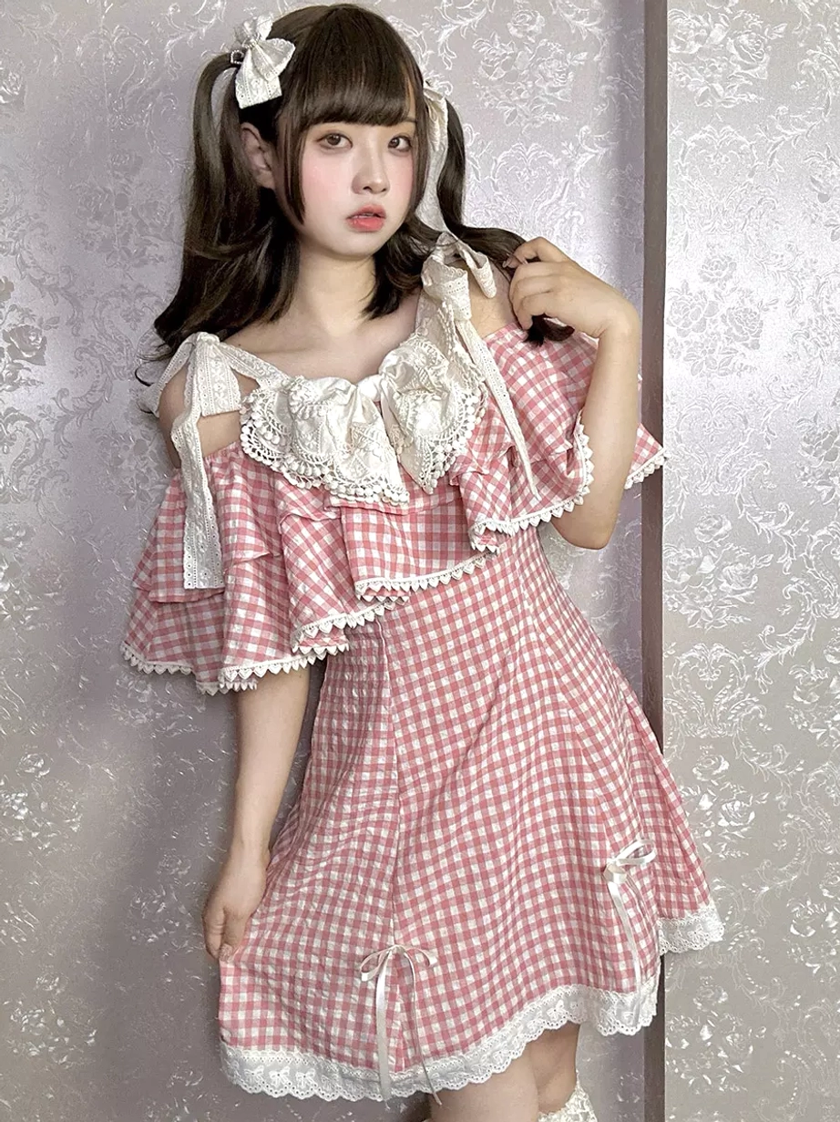 Pink white gingham Sweet Lolita mini dress with off-shoulder ruffle sleeves lace bow collar on female model with twin ponytails front three quarter view