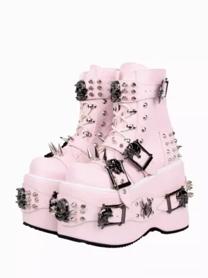 Front oblique view of pink gothic lolita platform boots with metal rivets and skull decorations, showing lace-up design and metallic embellishments on white background